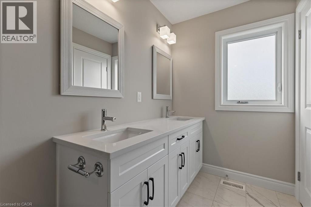 Full bathroom featuring double vanity and light marble finish flooring - 256 Keeso Lane, Listowel, ON - Indoor Photo Showing Bathroom