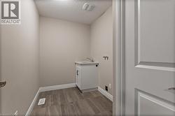 Washroom featuring a textured ceiling, hookup for a washing machine, and cabinet space -