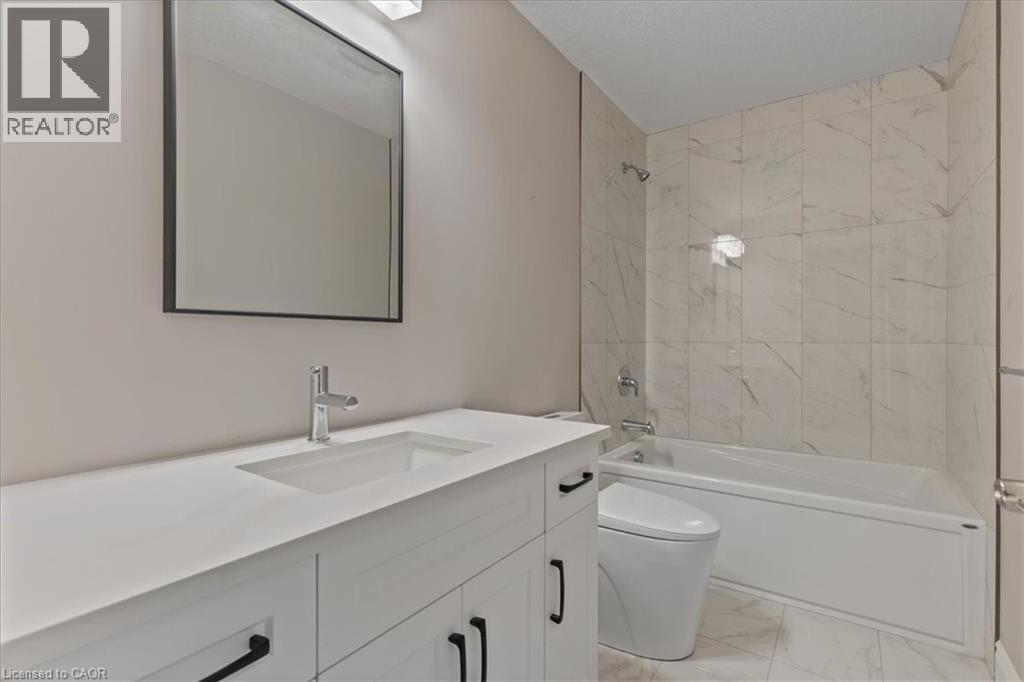 Full bathroom with shower / tub combination, vanity, and light marble finish flooring - 256 Keeso Lane, Listowel, ON - Indoor Photo Showing Bathroom