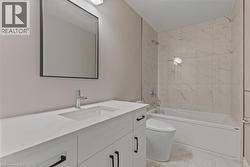 Full bathroom with shower / tub combination, vanity, and light marble finish flooring -