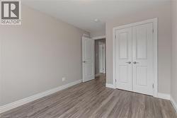 Unfurnished bedroom featuring wood finished floors and a closet -