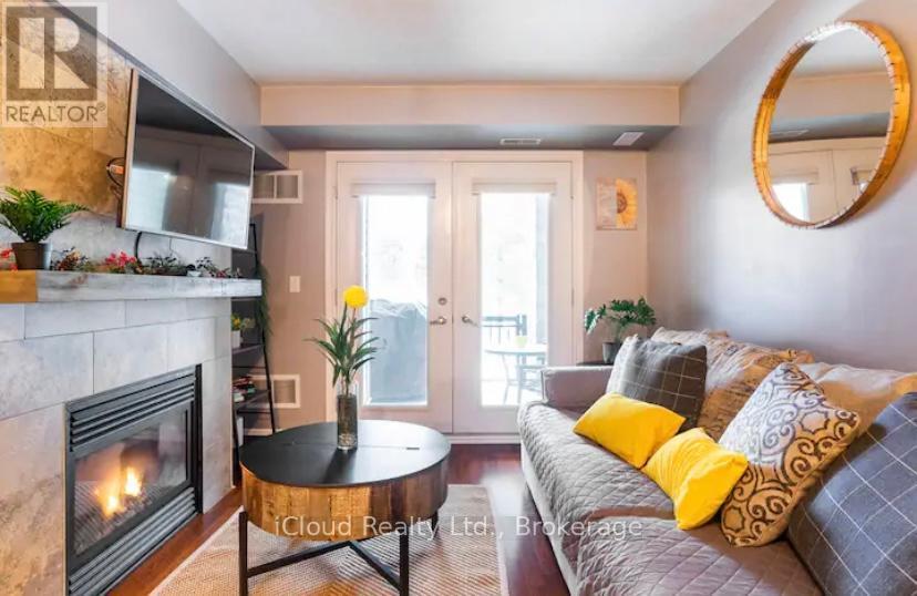 104 - 1 Brandy Lane Drive, Collingwood, ON - Indoor Photo Showing Living Room With Fireplace