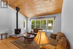 Living room with vaulted wood ceiling. -