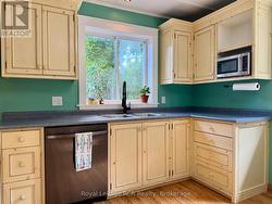 Custom cabinetry, dishwasher, and double sink. -