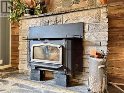 Stone fireplace w/efficient airtight wood insert. -