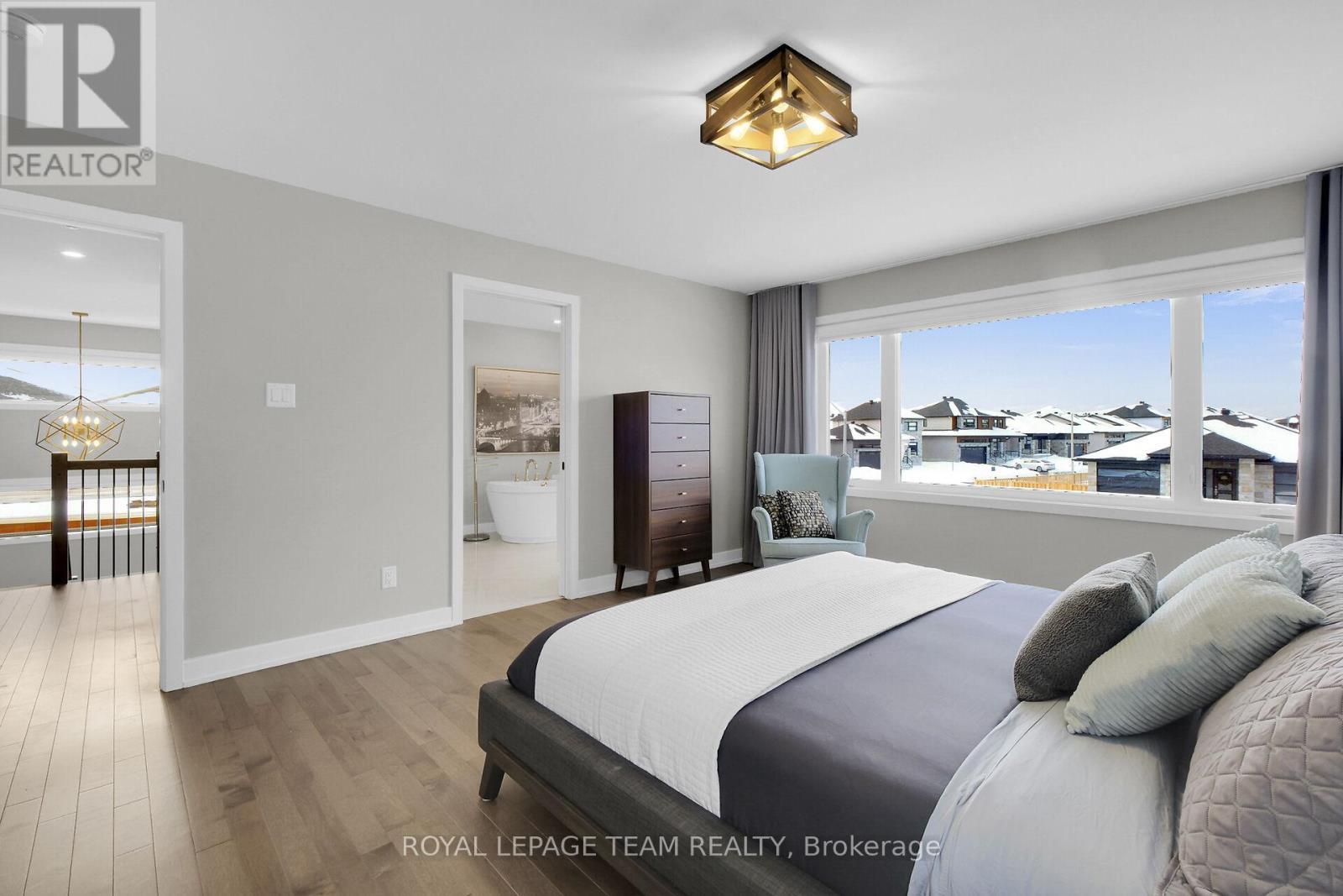 Hardwood floors & large window in Primary BR. - 504 Barrage Street, Casselman, ON - Indoor Photo Showing Bedroom