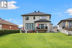 Large deck overlooks backyard. -