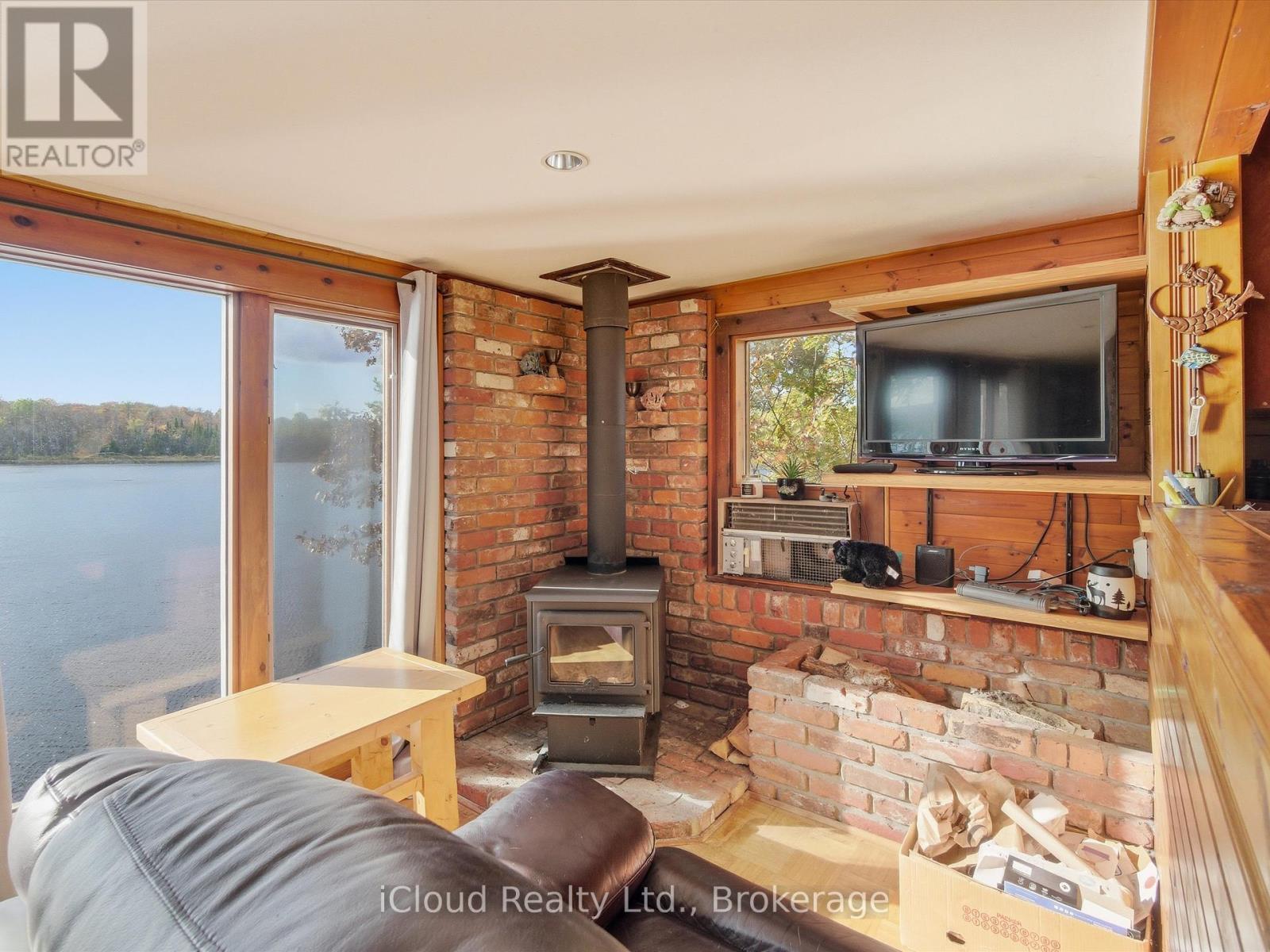 1128 124 Highway, Whitestone, ON - Indoor Photo Showing Living Room With Fireplace
