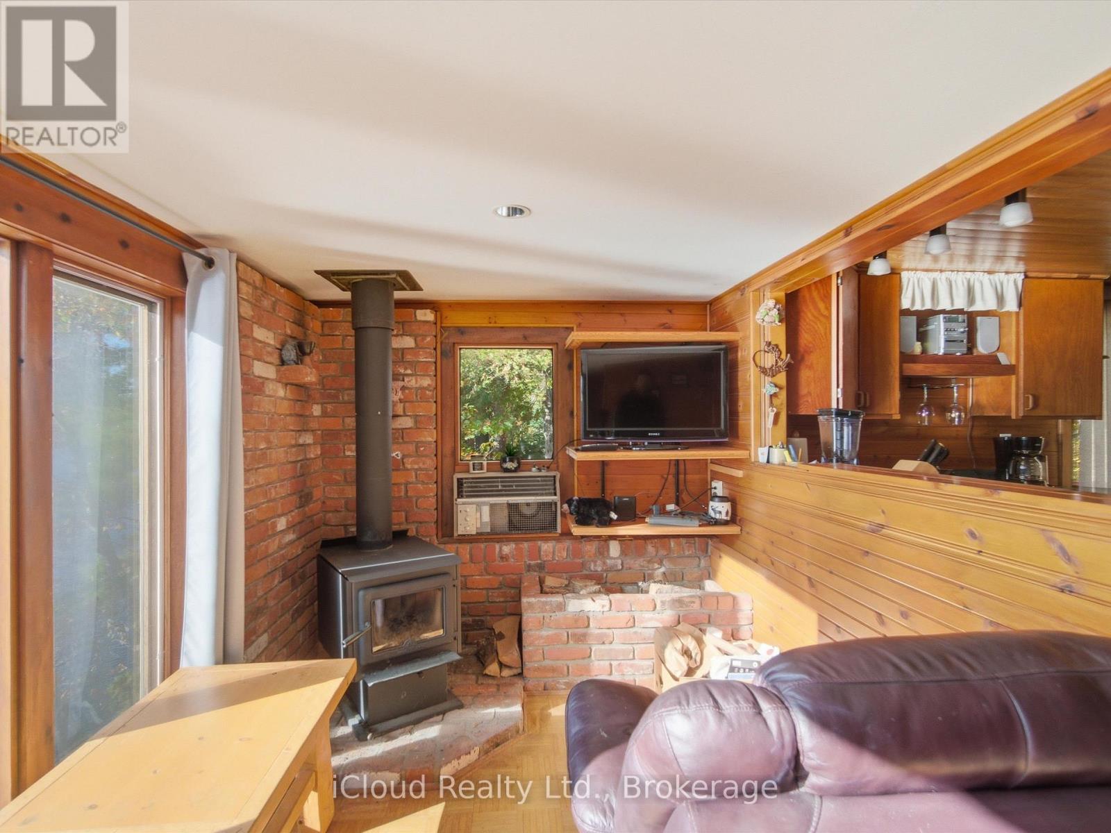 1128 124 Highway, Whitestone, ON - Indoor Photo Showing Living Room With Fireplace
