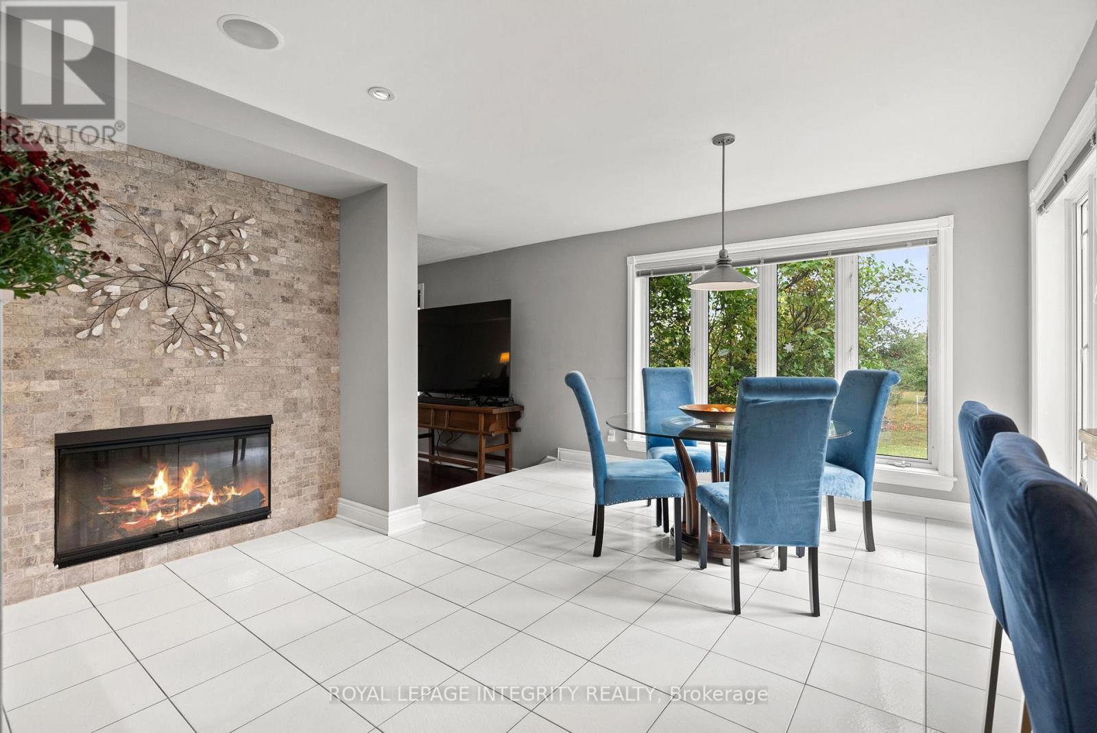 Large \"Breakfast Nook\" with double sided fireplace - 6 Marchbrook Circle, Ottawa, ON - Indoor With Fireplace