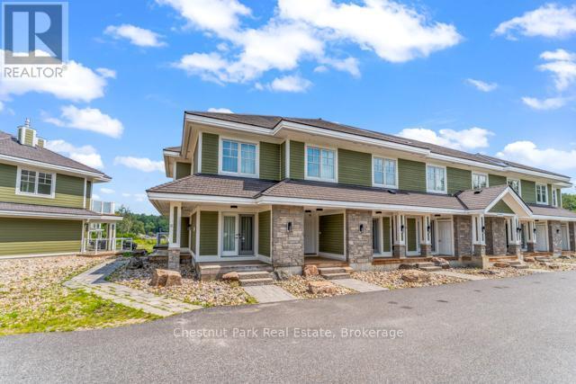 B#206 - 1869 Muskoka Road 118 Highway W, Muskoka Lakes (Monck (Muskoka Lakes)), ON - Outdoor With Deck Patio Veranda With Facade