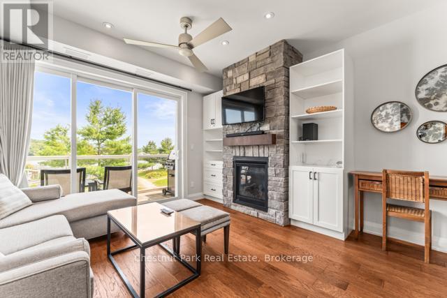 B#206 - 1869 Muskoka Road 118 Highway W, Muskoka Lakes (Monck (Muskoka Lakes)), ON - Indoor Photo Showing Living Room With Fireplace