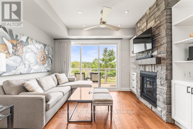 B#206 - 1869 Muskoka Road 118 Highway W, Muskoka Lakes (Monck (Muskoka Lakes)), ON - Indoor Photo Showing Living Room With Fireplace