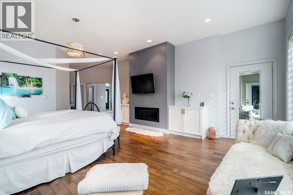 85 Hanley Way, Edenwold Rm No.158, SK - Indoor Photo Showing Bedroom With Fireplace