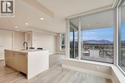 Dining space to the right of the kitchen with living room in front of island -