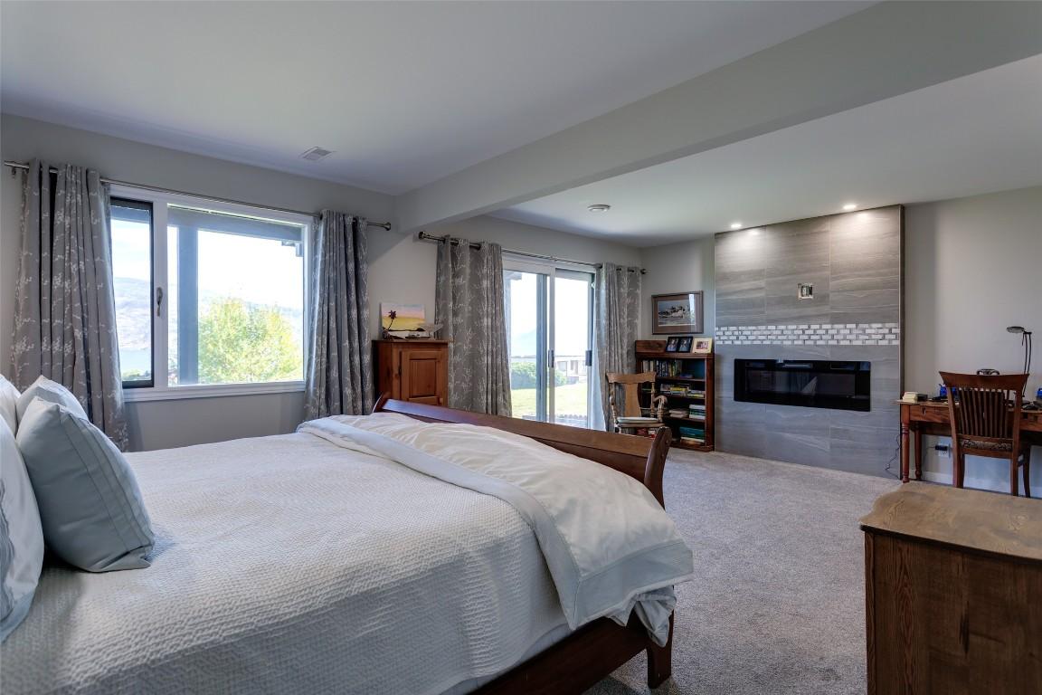 104-5970 Princess Street, Peachland, BC - Indoor Photo Showing Bedroom With Fireplace