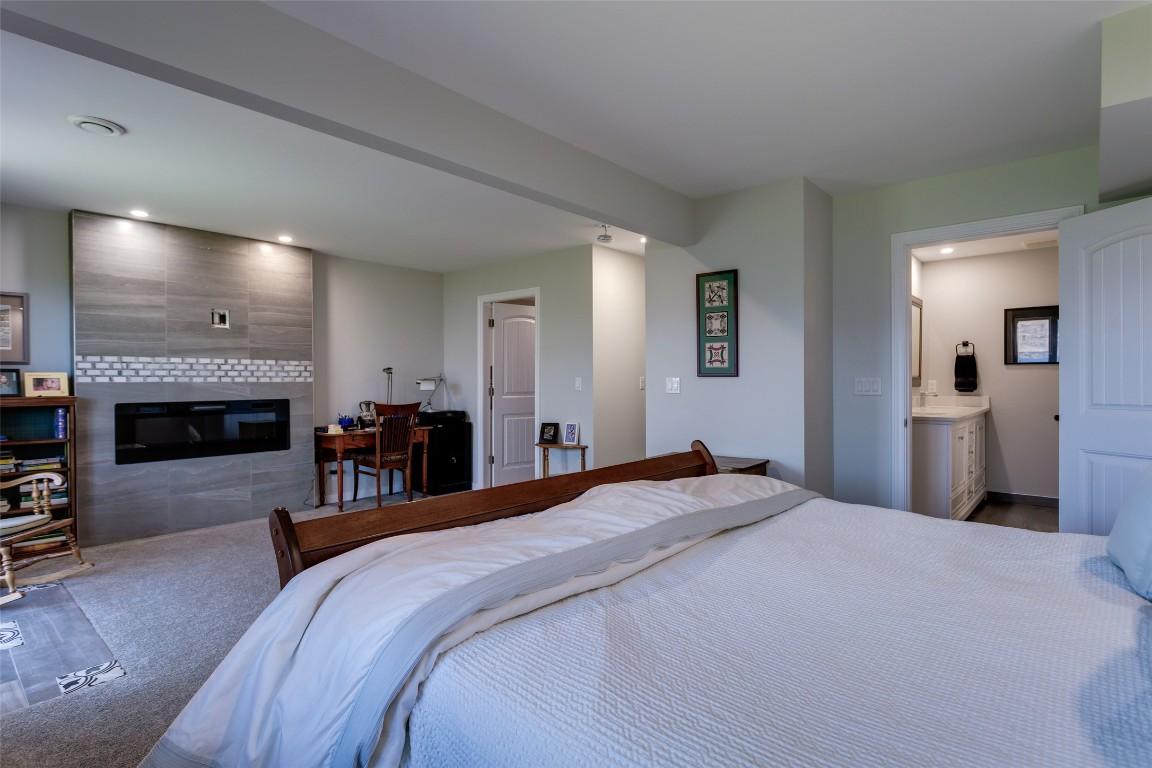 104-5970 Princess Street, Peachland, BC - Indoor Photo Showing Bedroom With Fireplace