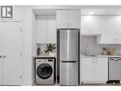 Kitchen & Laundry- Photos are of a similar home; some features may vary -