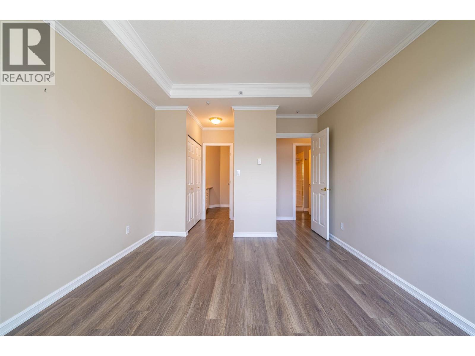 Primary Bedroom looking towards the ensuite bathroom and double closets - 3300 Centennial Drive Unit# 411, Vernon, BC - Indoor Photo Showing Other Room