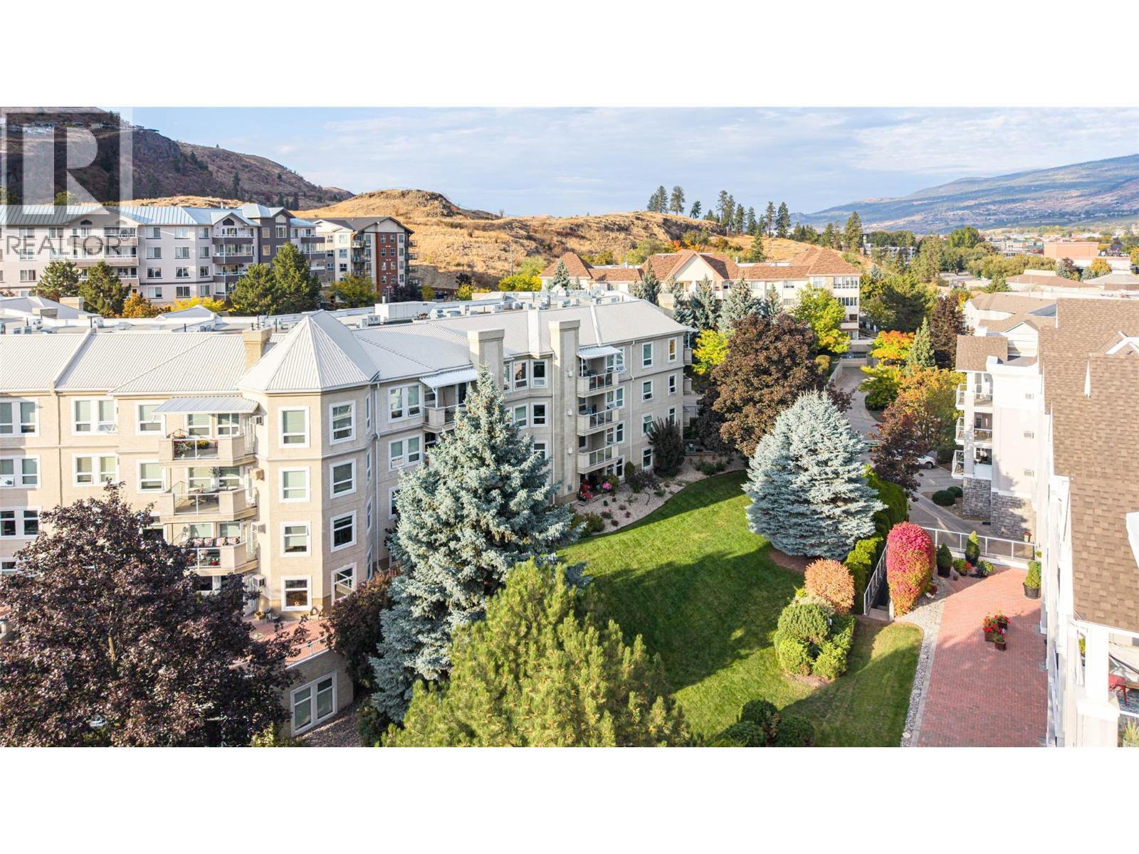 aerial view of Regency Court with manicured greenspace and grounds to the west/south/and east - 3300 Centennial Drive Unit# 411, Vernon, BC - Outdoor With View