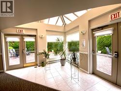 recreation room with bright atrium opening up on common terrace /patio -