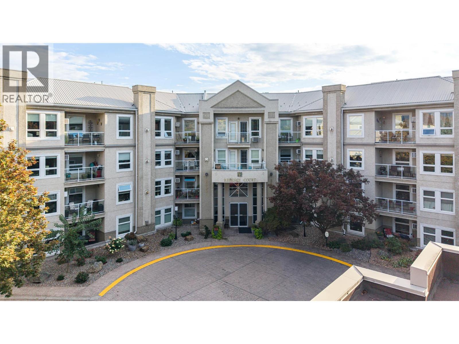 Front courtyard entrance door of building - 3300 Centennial Drive Unit# 411, Vernon, BC - Outdoor With Balcony With Facade