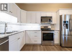 Modern kitchen w/ under counter lighting full, tile backsplash, soft close cabinets with lots of storage space -