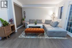 Living room with wood finished floors and baseboards -