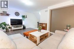 Living area with wood finished floors and baseboards -