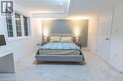 Carpeted bedroom with baseboards -