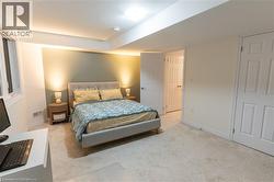Bedroom featuring light colored carpet and baseboards -