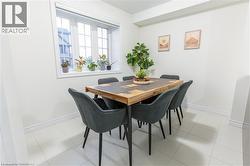 Dining space with baseboards and light tile patterned flooring -