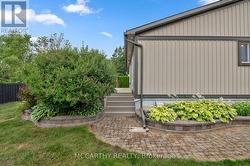 stairs to private deck, stone path and gardens -