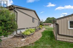 beautiful walk way with pave stone & gardens -