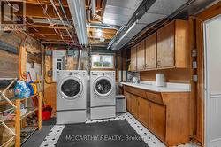 lower level laundry, with plenty of cabinet storag -