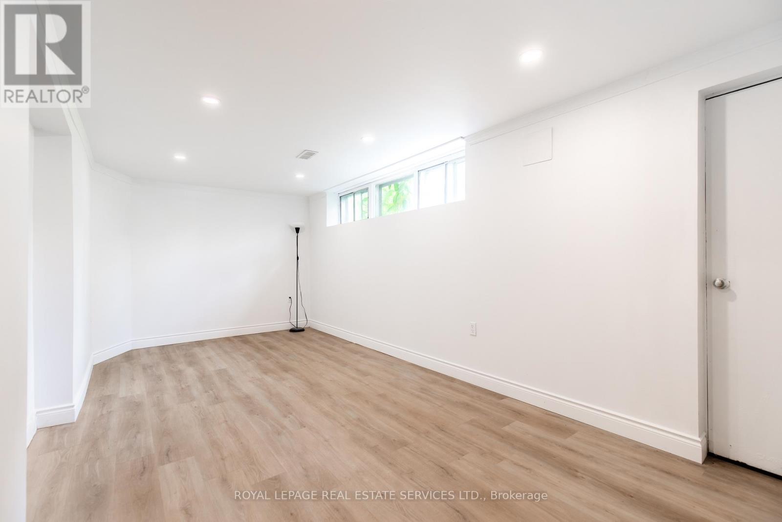 Lower level recreation room with large windows - Unit #2 - 227 Lakeshore Road W, Oakville, ON - Indoor Photo Showing Other Room