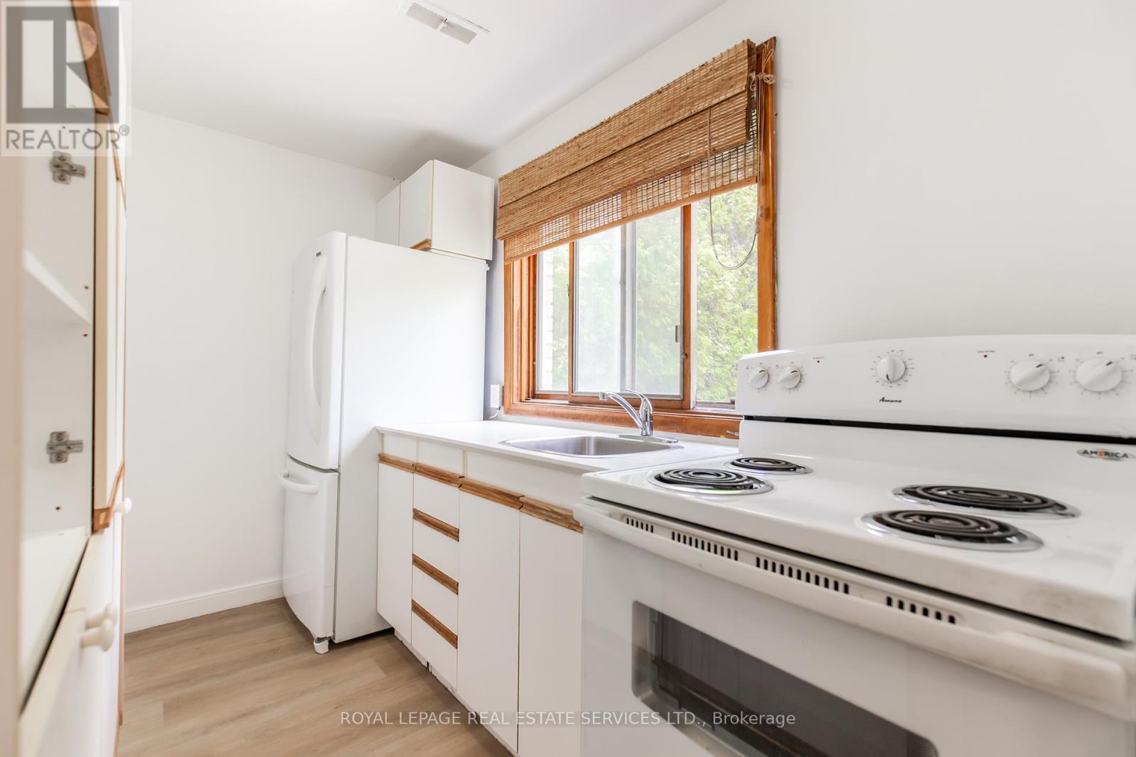 White kitchen w/ fridge & stove - Unit #2 - 227 Lakeshore Road W, Oakville, ON - Indoor Photo Showing Kitchen