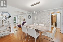 Formal Dining Room Features Hardwood Flooring -