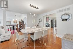 Formal Dining Room Features Hardwood Flooring -