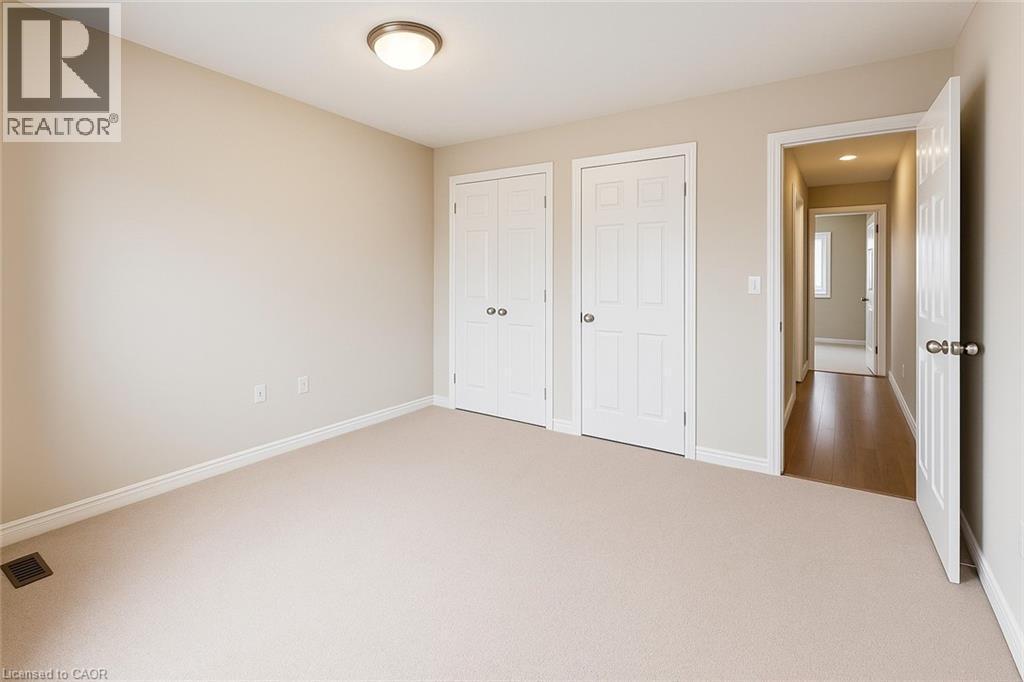 Unfurnished bedroom with carpet and baseboards - 6 Upper Mercer Street Unit# B6, Kitchener, ON - Indoor Photo Showing Other Room