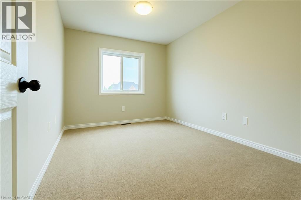 Carpeted empty room with baseboards - 6 Upper Mercer Street Unit# B6, Kitchener, ON - Indoor Photo Showing Other Room