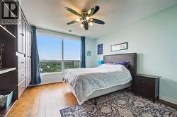 Bedroom with wood finished floors and ceiling fan -