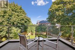 Primary Balcony Overlooking the Mature Backyard -