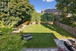 Primary Balcony Overlooking the Mature Backyard -