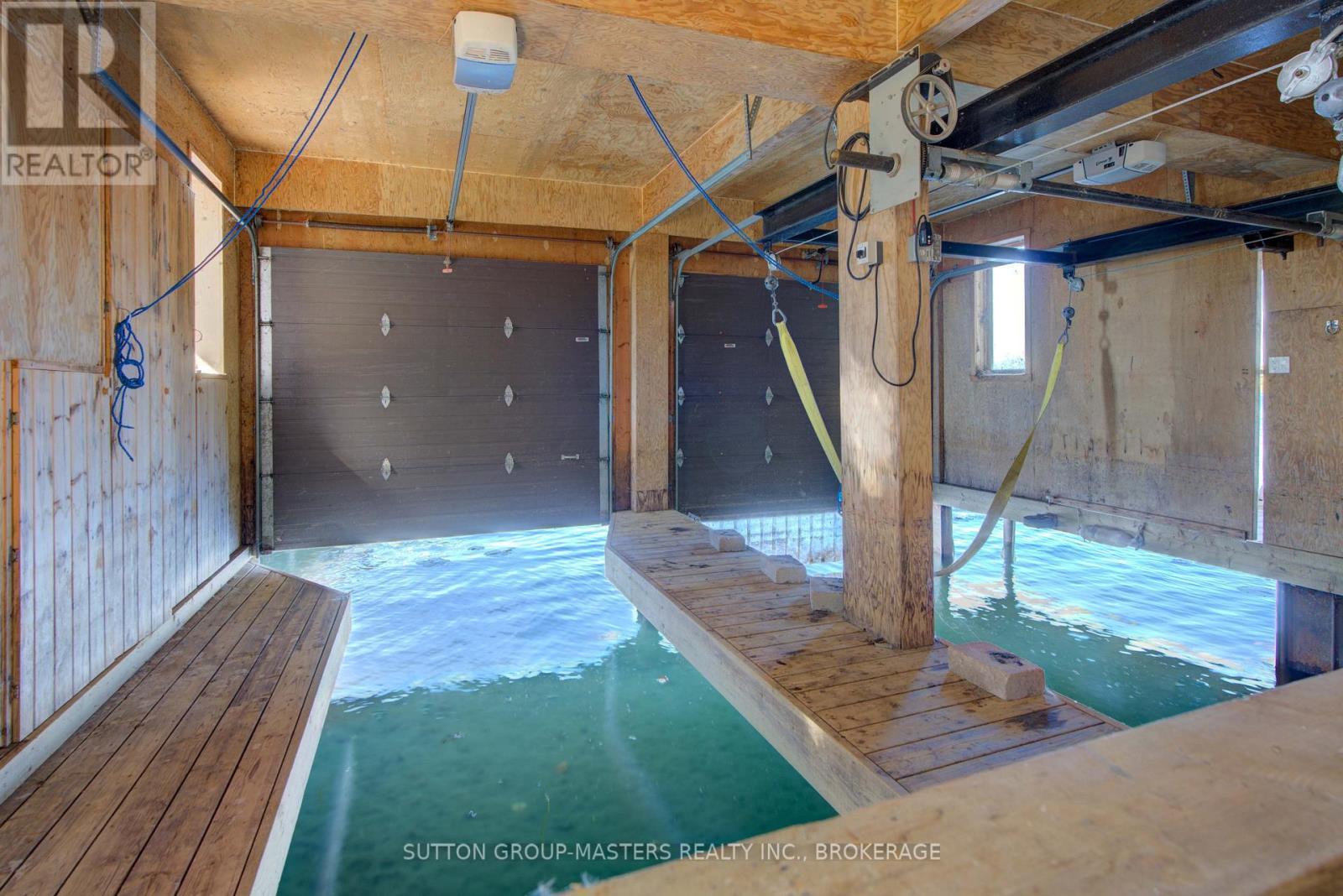 Lift for approx. 24 foot boat - 314 Baseline Road, Frontenac Islands (The Islands), ON - Indoor Photo Showing Garage