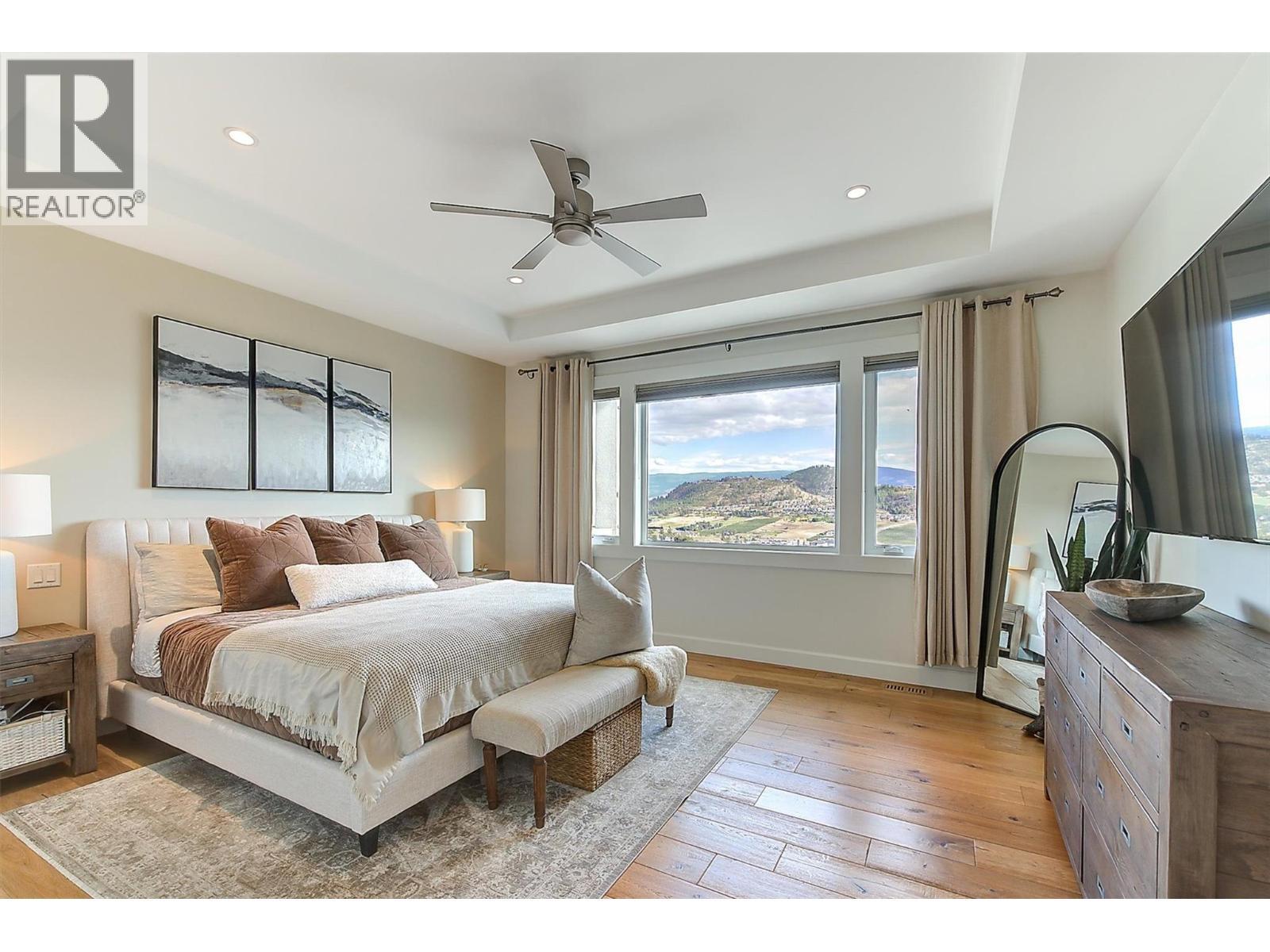 Main floor king-size primary bedroom features soaring ceilings - 738 Highpointe Drive, Kelowna, BC - Indoor Photo Showing Bedroom