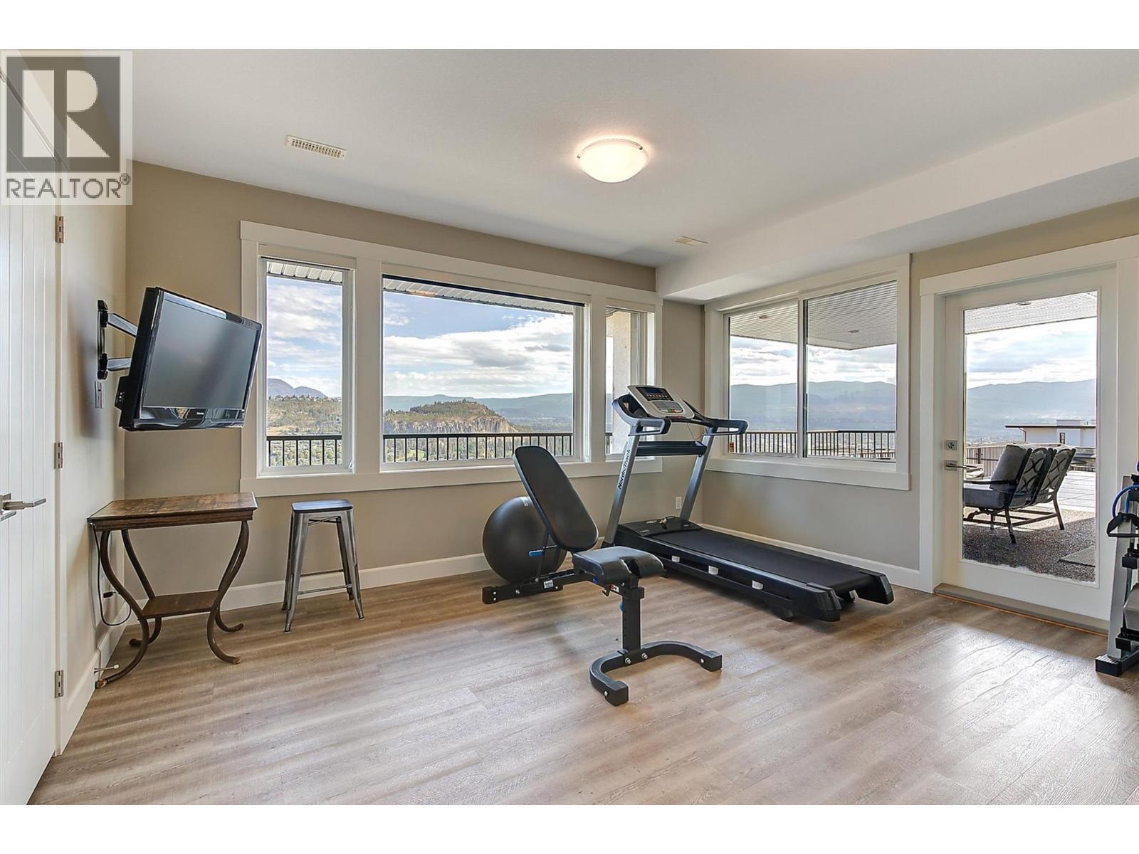 Could serve as a fourth bedroom on the lower level. - 738 Highpointe Drive, Kelowna, BC - Indoor Photo Showing Gym Room