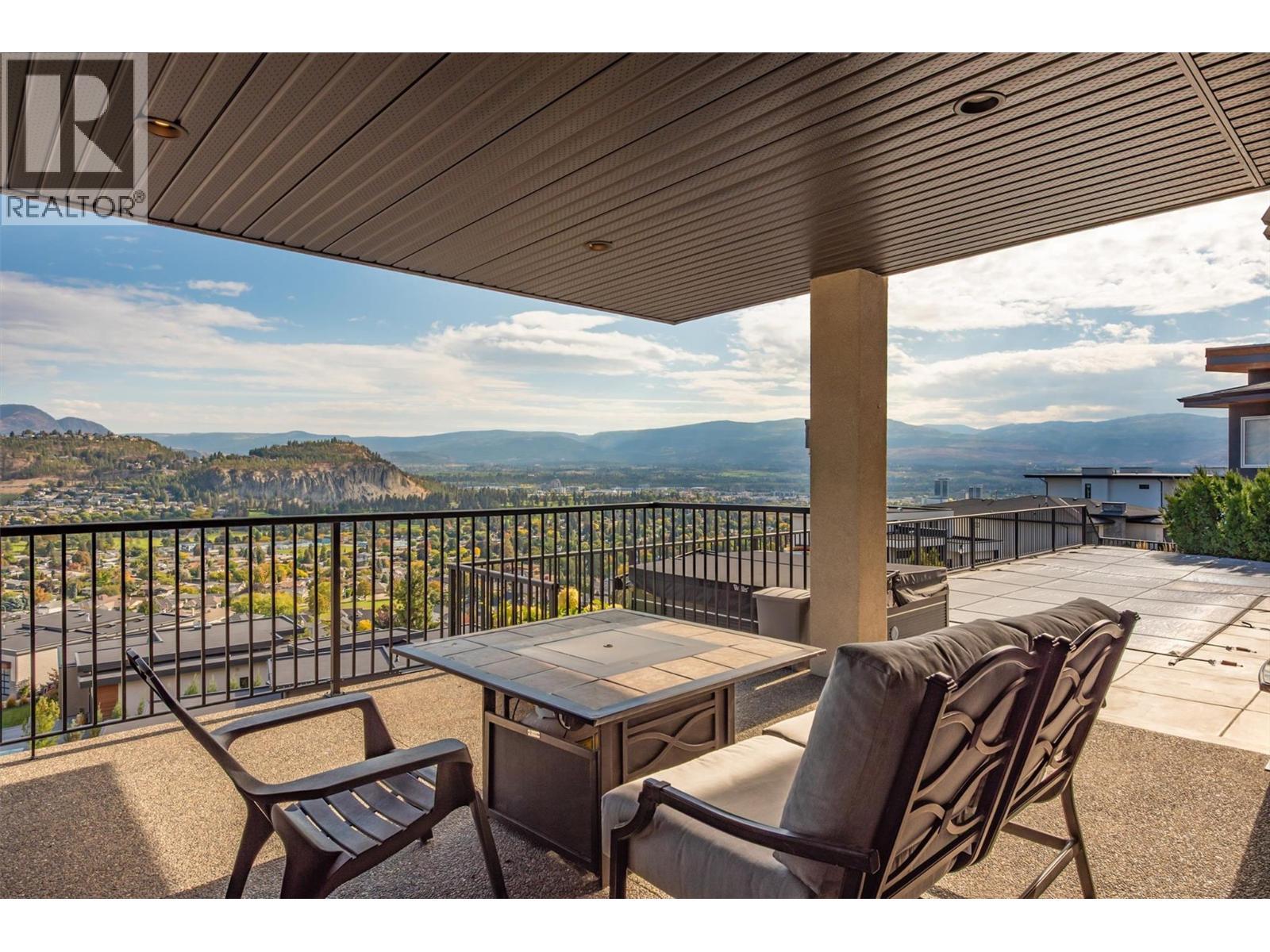 Home boasts multiple outdoor living areas, including a stunning main patio off the lower level family room and - 738 Highpointe Drive, Kelowna, BC - Outdoor With Deck Patio Veranda With View With Exterior