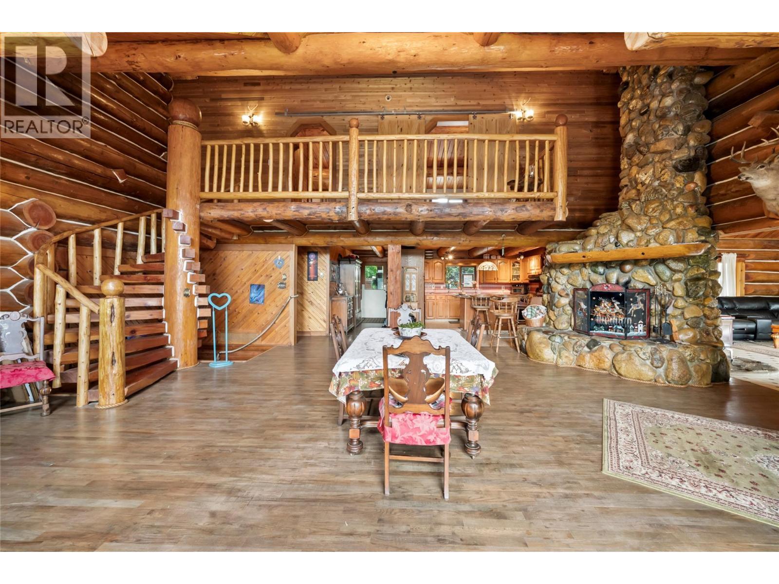 Great room with floor to ceiling rock fire place - 2462 Leisure Road, Blind Bay, BC - Indoor With Fireplace