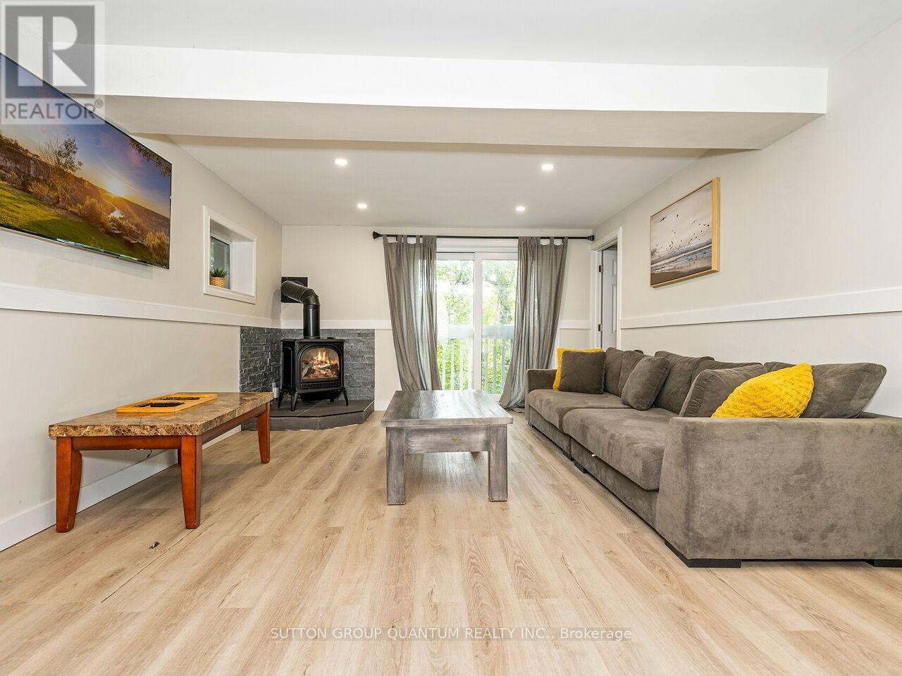8 - 1006 Youngs Road, Muskoka Lakes, ON - Indoor Photo Showing Living Room With Fireplace